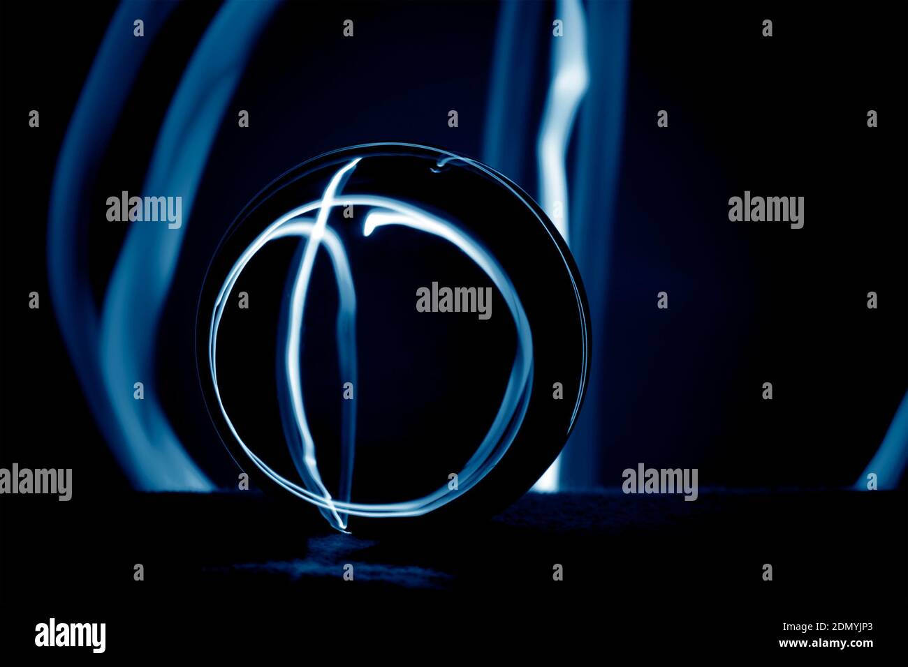 Abstrakte Komposition mit einer Kristallkugel in der Dunkelheit. Stockfoto