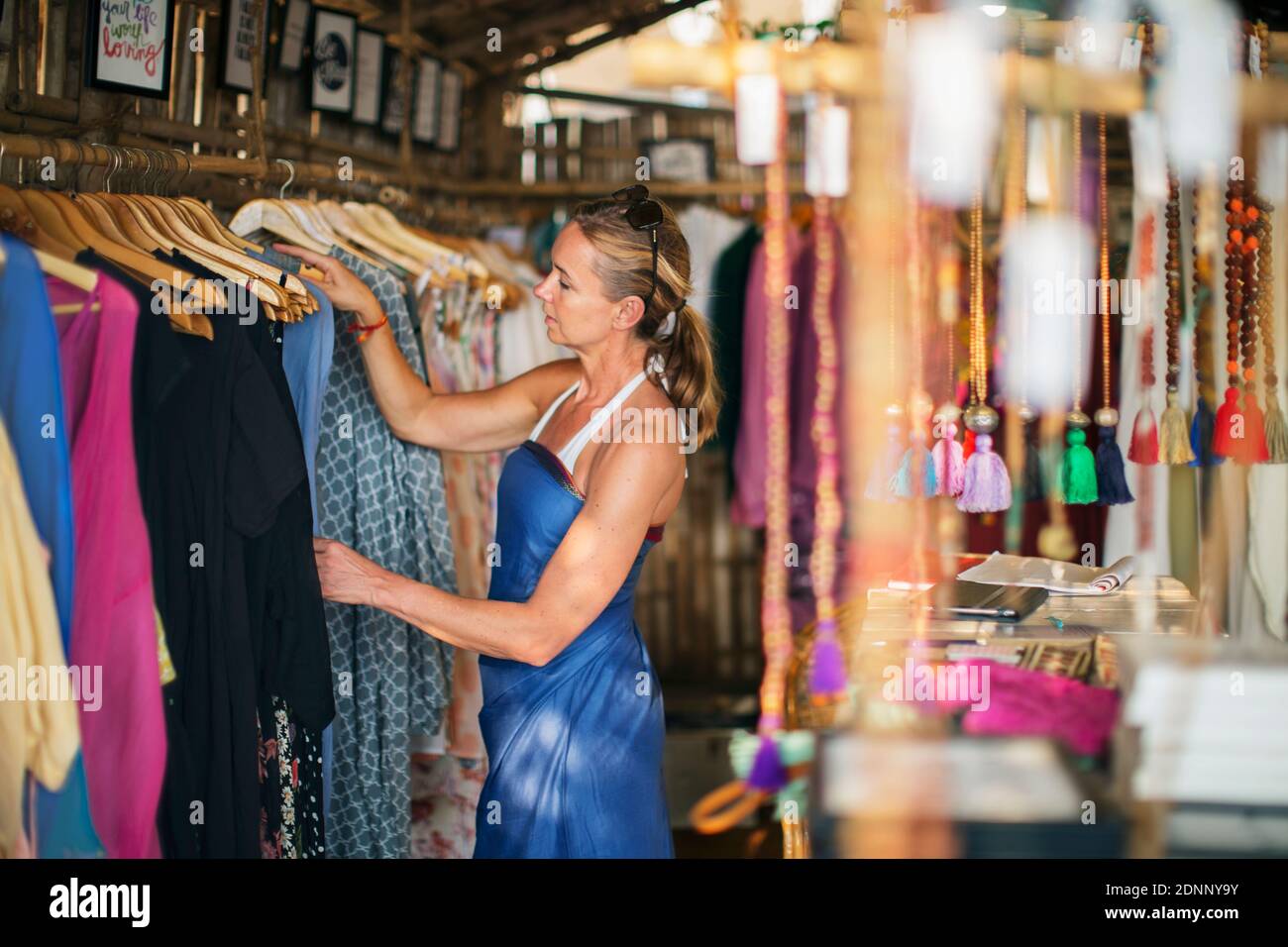 Frau, die Kleidung im Geschäft ansieht Stockfoto