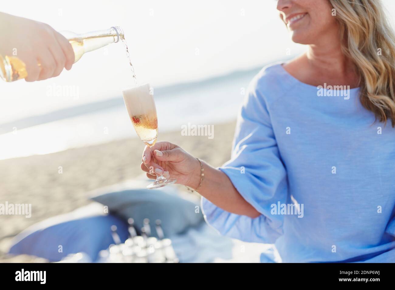 Frau mit Picknick am Strand Stockfoto