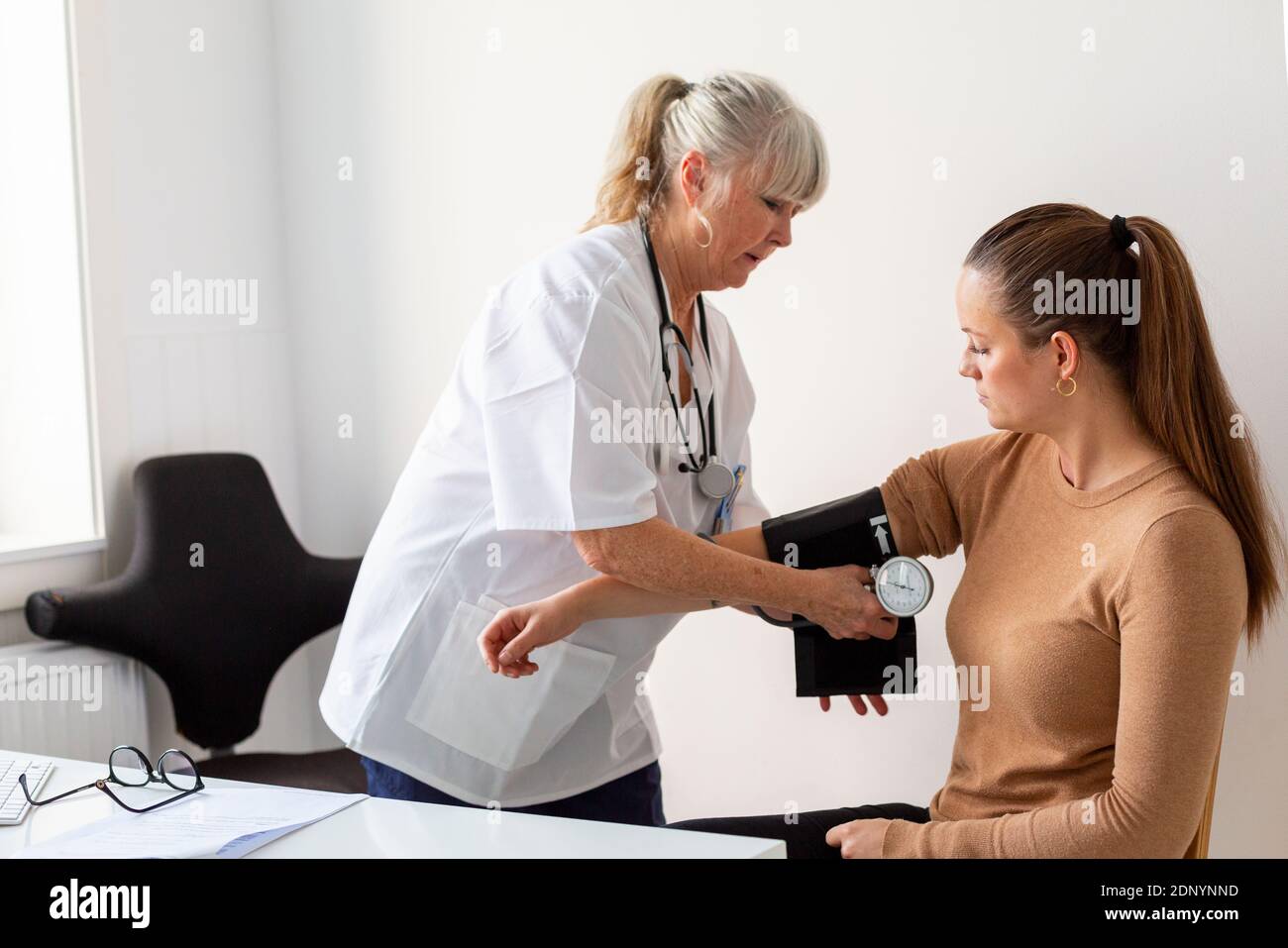Arzt messen Blutdruck Stockfoto