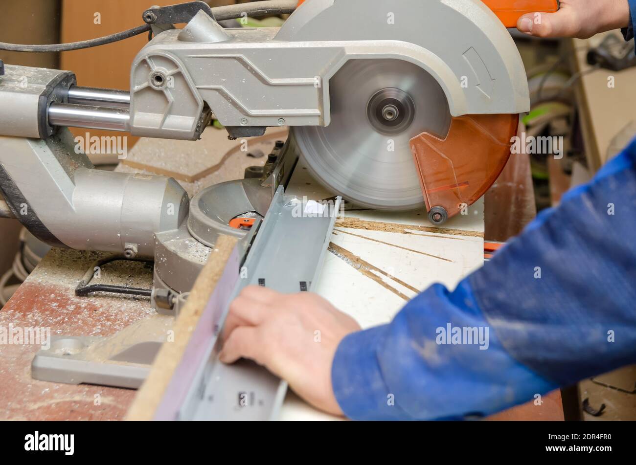 Arbeiter schneidet einen Teil des Metallrahmens mit einer Kreissäge zum  Schneiden von Aluminium ab. Sägen von Metall. Schleifmaschine  Stockfotografie - Alamy