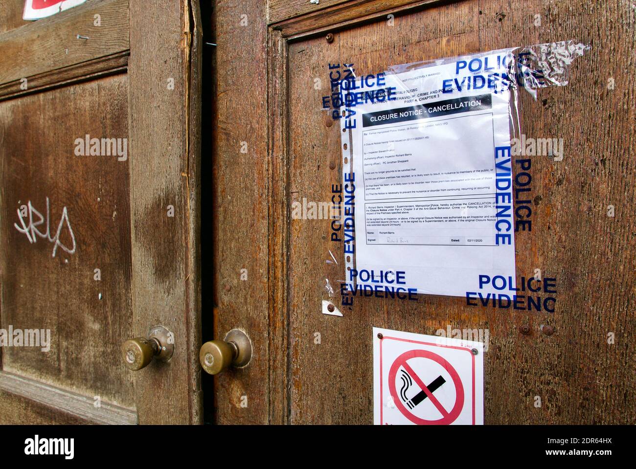 An der Holztür der Polizeiwache Hampstead wurde ein Hinweis zur Schließung verklebt. Anti-Social Behavior, Crime and Policing Act 2014. London. Stockfoto