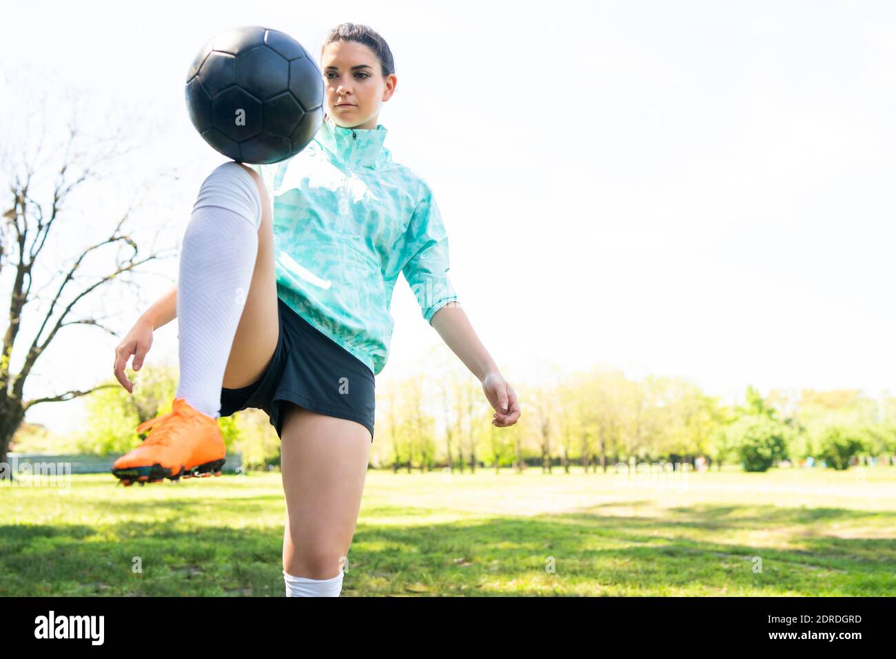 Junge Frau übt Fußball mit Ball. Stockfoto