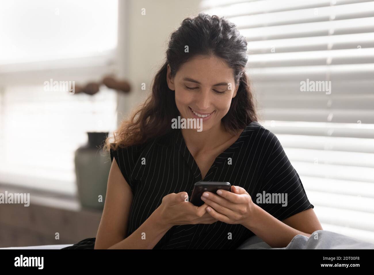 Lächelnde Frau betrachten Handy-Bildschirm Messaging Stockfoto