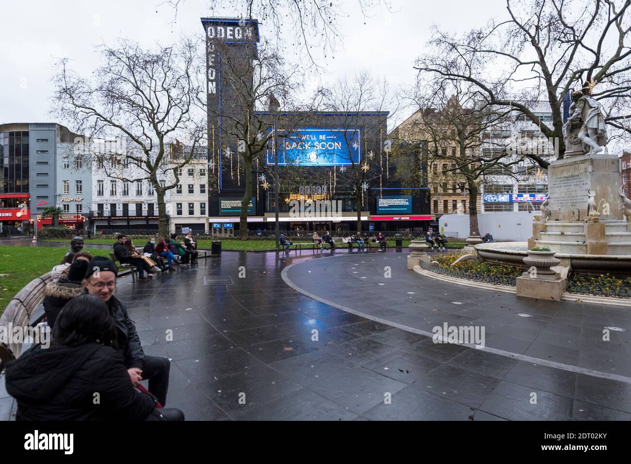 London, Großbritannien. 21 Dezember 2020. Das Odeon Leicester Square Kino zeigt ein großes digitales Zeichen mit dem Text "Wir werden bald wieder". Kinos, Theater und andere Live-Veranstaltungsorte haben während der Pandemie besonders stark gelitten, und es ist derzeit nicht geplant, sie wieder zu eröffnen. Tier-4-Beschränkungen werden für einen Großteil des Vereinigten Königreichs auferlegt, um die laufende Coronavirus-Pandemie im Lichte eines kürzlich entdeckten mutierten Stammes zu bekämpfen, der sich im Südosten Englands ausbreitet. Kredit: Stephen Chung / Alamy Live Nachrichten Stockfoto