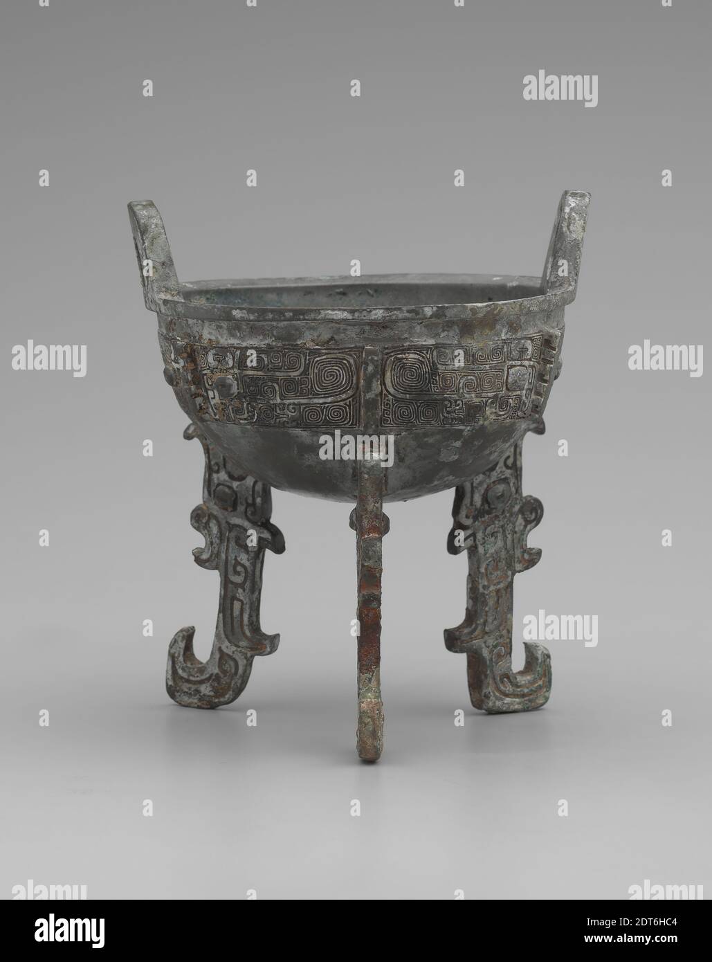 Ritualgefäß (Ding), Bronze, 6 1/2 × 5 3/4 Zoll (16.5 × 14.6 cm) wurden frühe chinesische Bronzegefäße mit einer unverwechselbaren Piece-Mould-Technologie gegossen, in der mehrere Keramikstücke einzeln geschnitzt und um einen Tonkern zusammengesetzt wurden. Der Raum zwischen dem inneren Kern und den Formen wurde dann mit geschmolzener Bronze gefüllt, und nach dem Trocknen der Bronze wurden der keramische Kern und die Formen entfernt. Die dichten Verzierungen und ineinandergreifenden Entwürfe auf diesem Beispiel wurden in die Tonformen in der Rückseite geschnitzt, so dass sie richtig auf dem fertigen Schiff lesen würde., China, Chinesisch, Shang-Dynastie Stockfoto