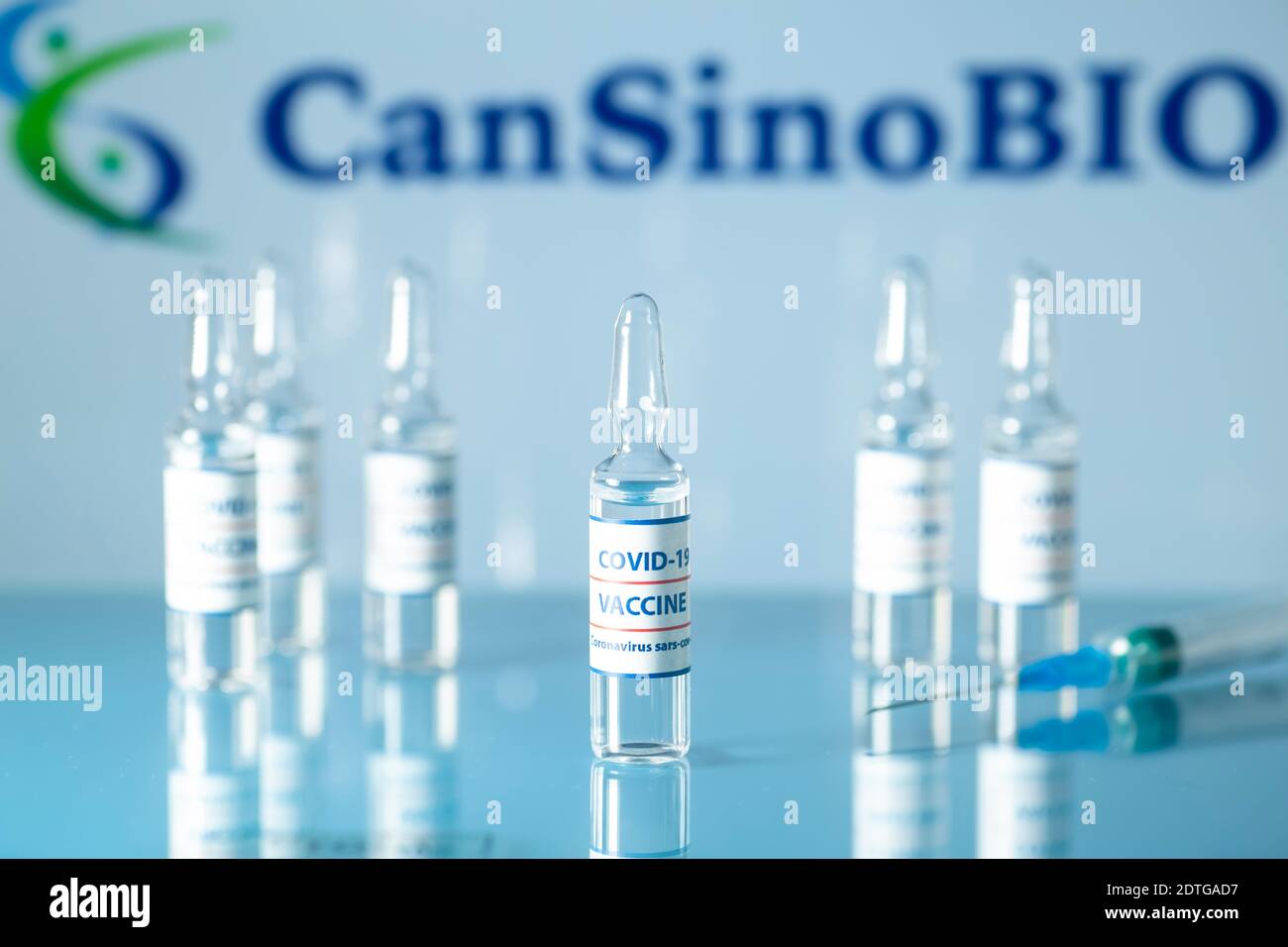 CanSinoBIO chinese vaccine against COVID-19. Glass medical vials with liquid on the background Can Sino Bio company logo. Ampoules with coronavirus va Stockfoto