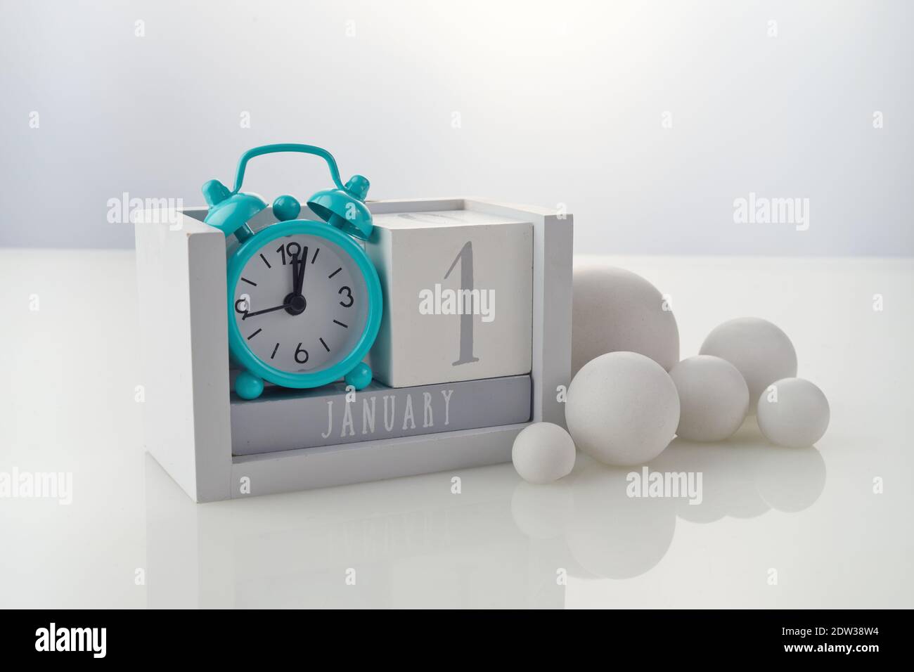 1. januar Holzkalender mit Dekorationen auf weißem Tischhintergrund Stockfoto
