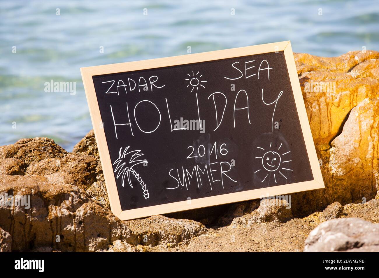 Blacboard mit Urlaubstext am Strand Stockfoto