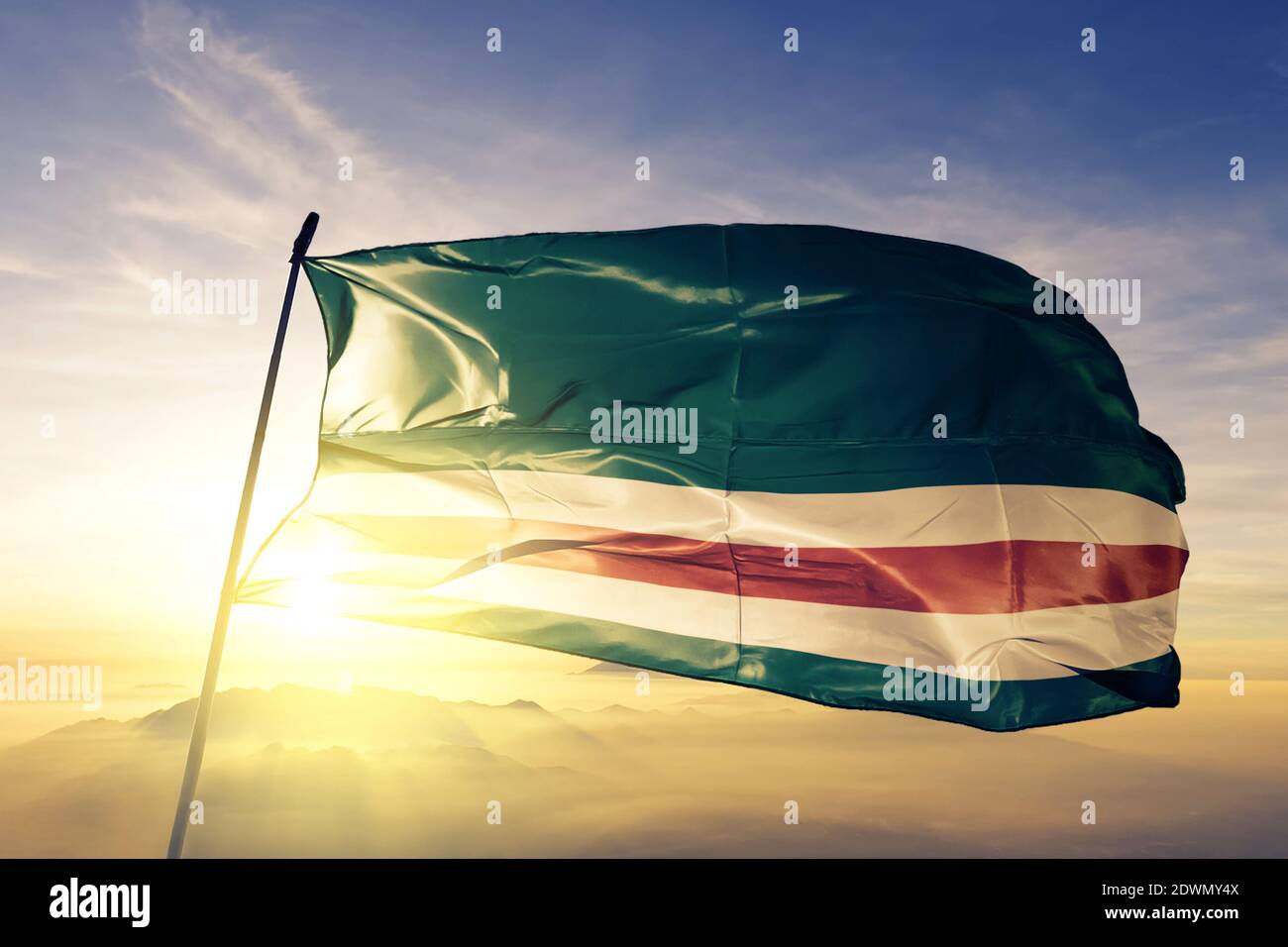 Tschetschenische Republik Itschkeria Flagge winkt auf der Spitze Sonnenaufgang Nebelnebel Stockfoto
