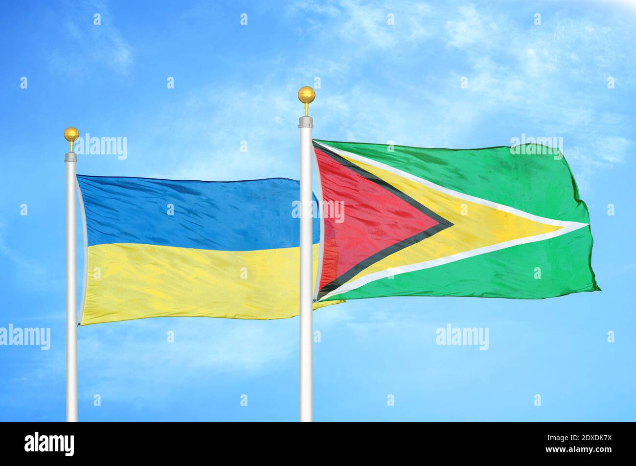Ukraine und Guyana zwei Flaggen auf Fahnenmasten und blauer Himmel Stockfoto