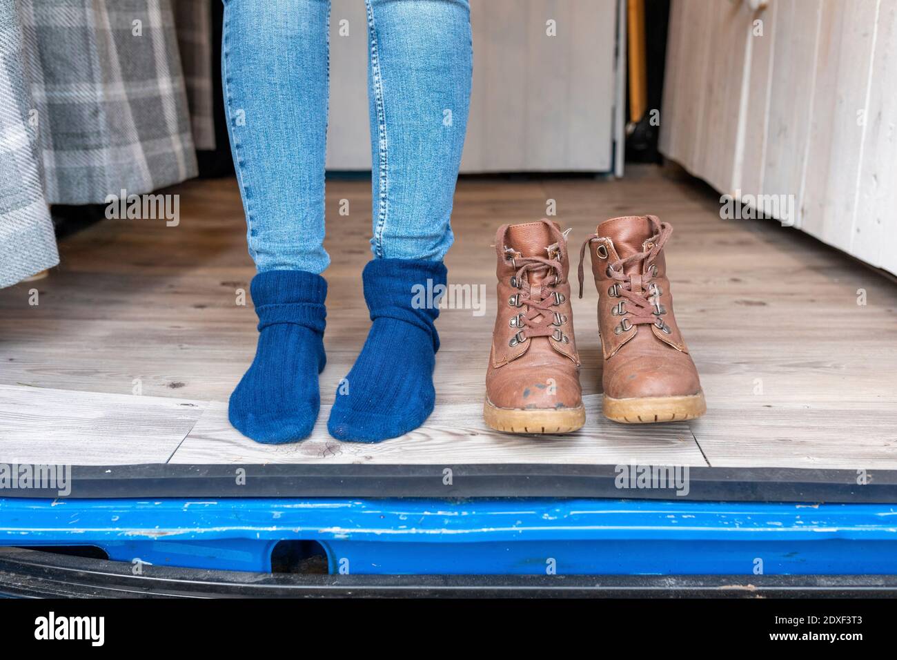 Weibliche Füße und Stiefel an der Tür eines Campers Van Stockfoto