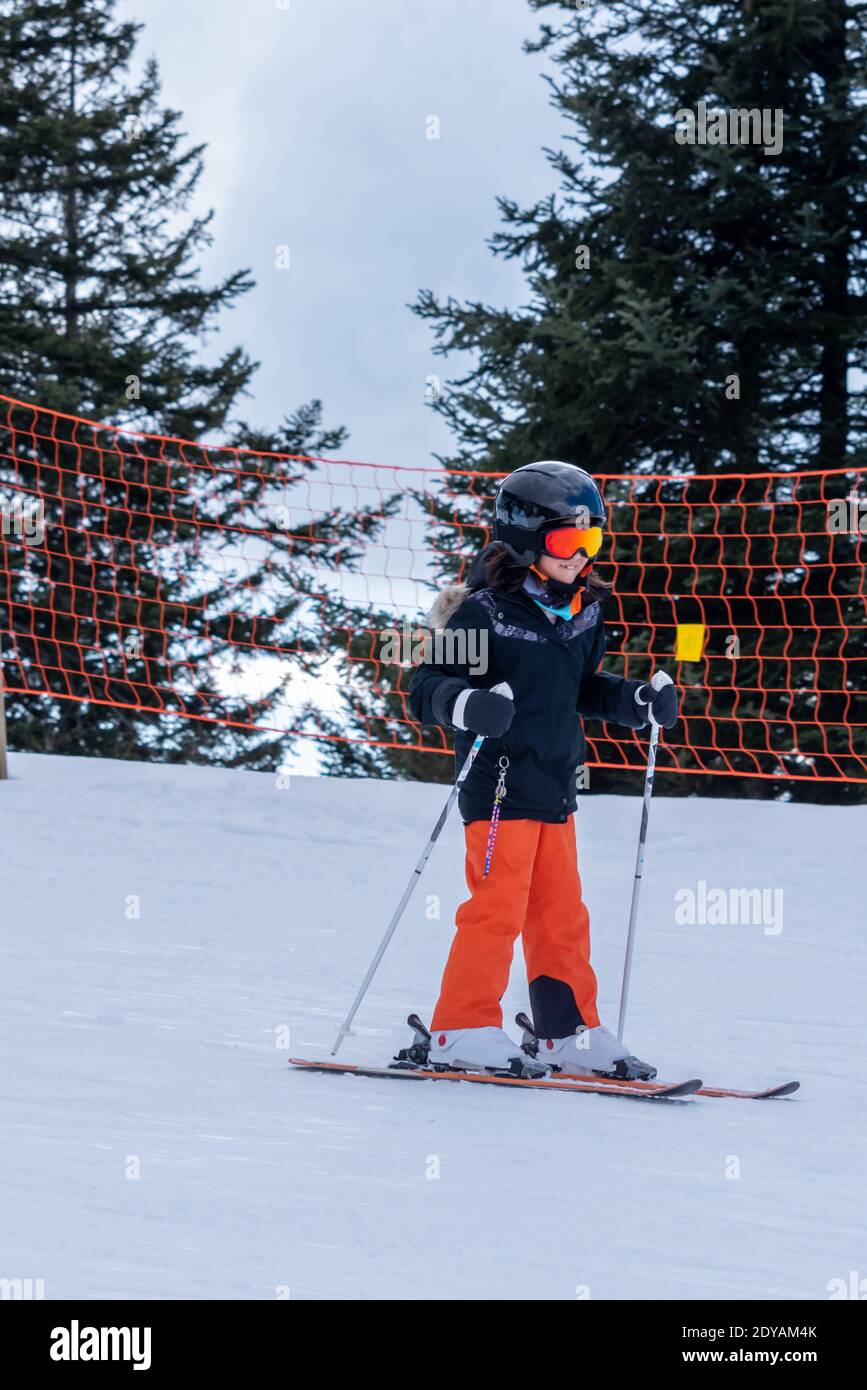 Skifahren im Schnee. Ein asiatischer Kinderskifahrer auf der Skipiste. Urlaub in der Schweiz. Frohe Kindheit. Stockfoto