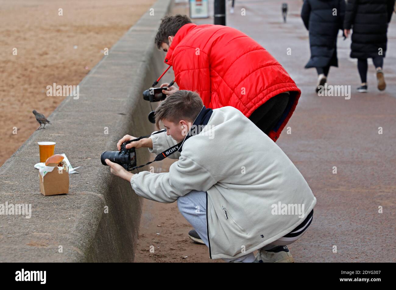 Portobello, Edinburgh, Schottland, Großbritannien. 26 Dezember 2020. Am zweiten Weihnachtsfeiertag, bevor der Regen um 11 Uhr einsetzte. Temperatur von 5 Grad Celsius echtes Gefühl -2 Grad. Zwei Fotografen fotografieren Essen und Trinken für die Beach House Cafe Website, die geöffnet sind. Portobello Beach wird derzeit in den ersten zehn Minuten von George Clooney's neuestem Film Midnight Sky, "There's a Place called Portobello Beach ... Es ist so schön, dass Sie es direkt vor der Küste in der Nähe von Edinburgh gehen sollten. Quelle: Arch White/Alamy Live News. Stockfoto