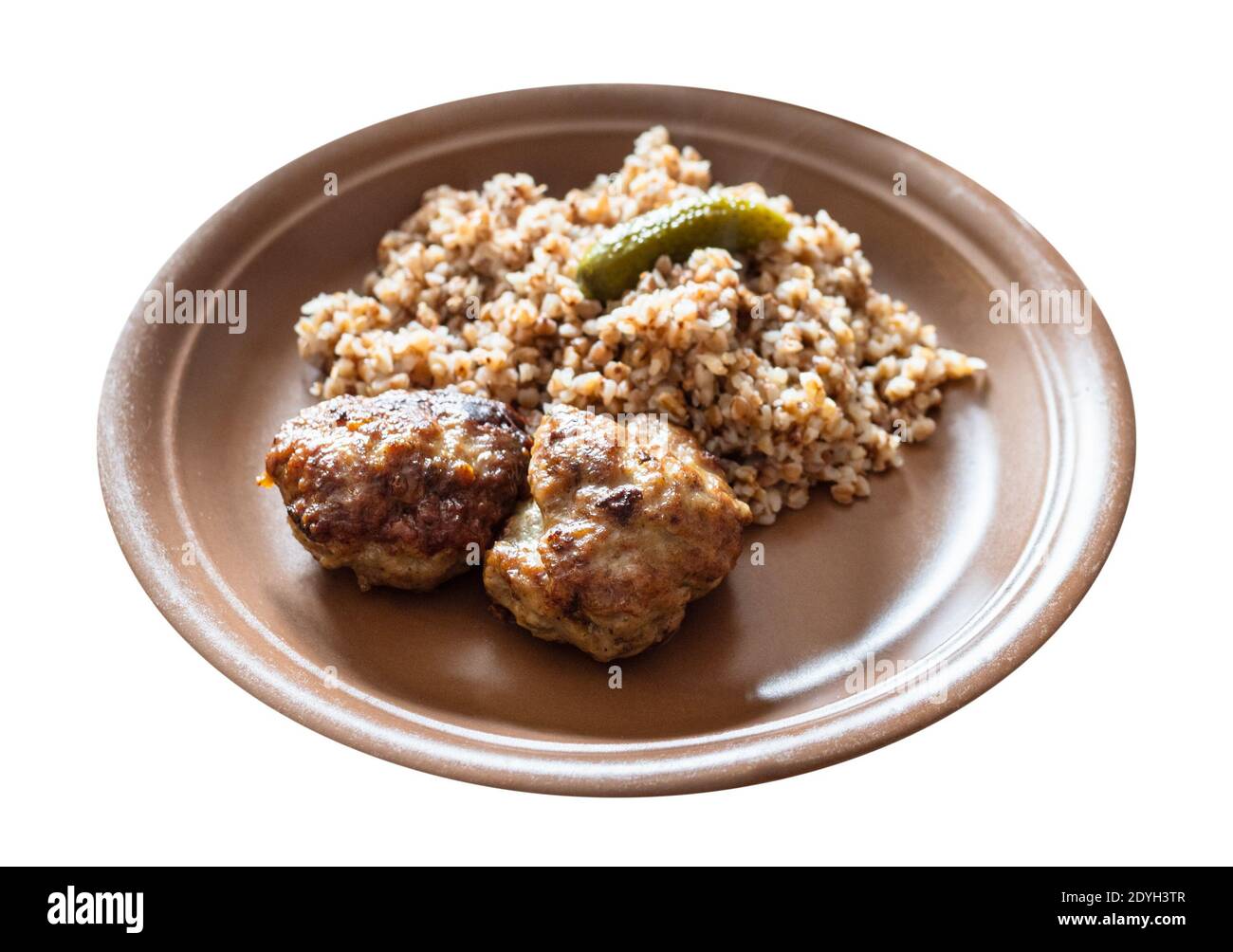 Portion gebratene Kotleta (panierte Hacksteaks), Beilage aus gekochtem Buchweizenbrei auf braunem Teller, auf weißem Hintergrund ausgeschnitten Stockfoto