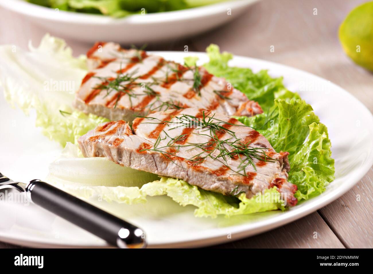 Gegrillter Thunfisch mit Salat auf einem Teller bereit zum Essen. Stockfoto