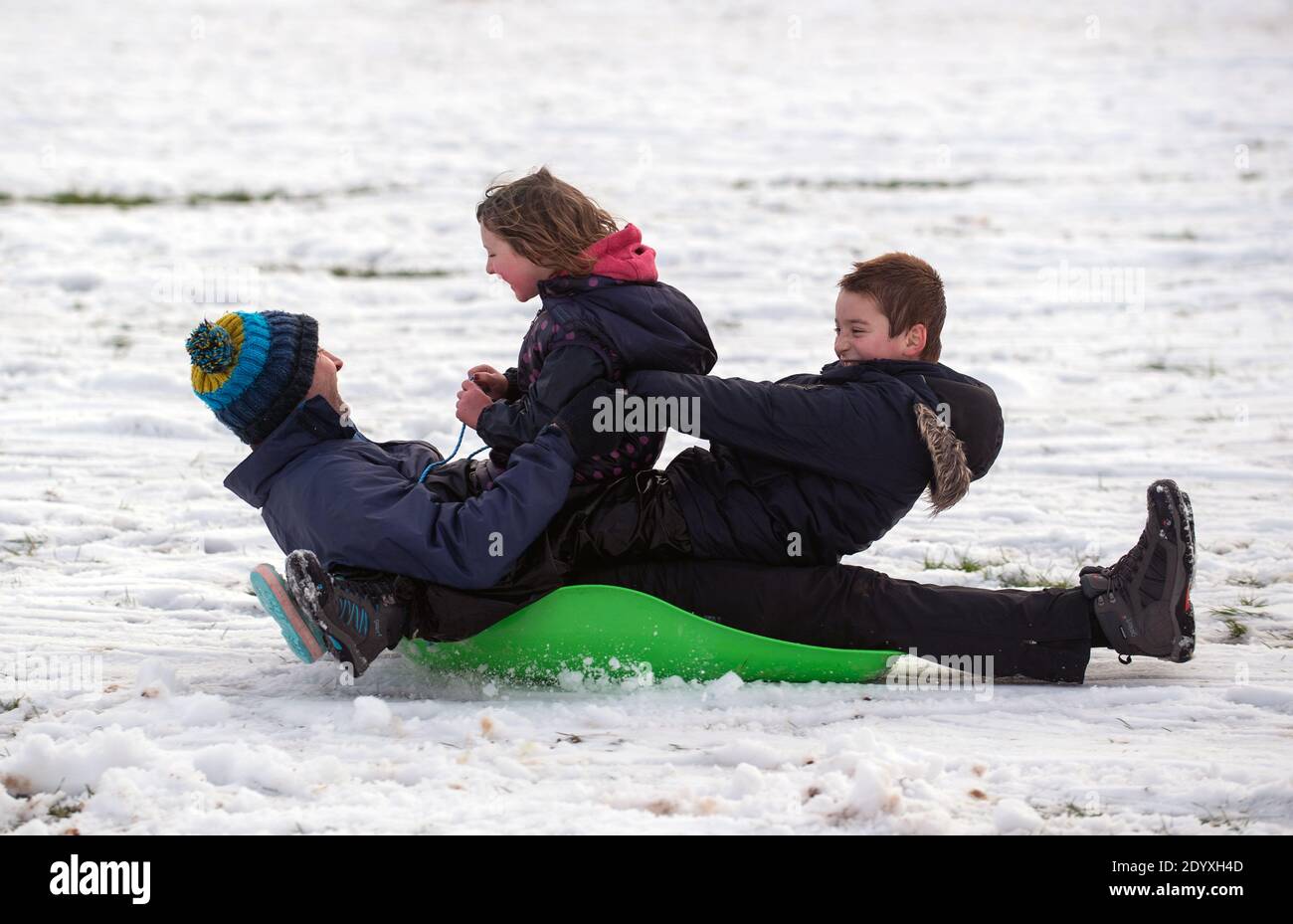 Menschen Rodeln im Schnee in einem Park in Newcastle-under-Lyme, Staffordshire. Stockfoto