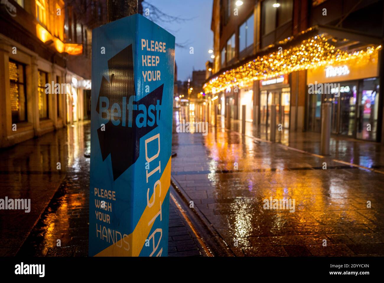 Ein Schild mit der Nachricht: Belfast, Please Keep Your Distance, Please Wash Your Hands, auf der William Street South in Belfast am dritten Tag einer sechswöchigen Sperre in Nordirland. Stockfoto