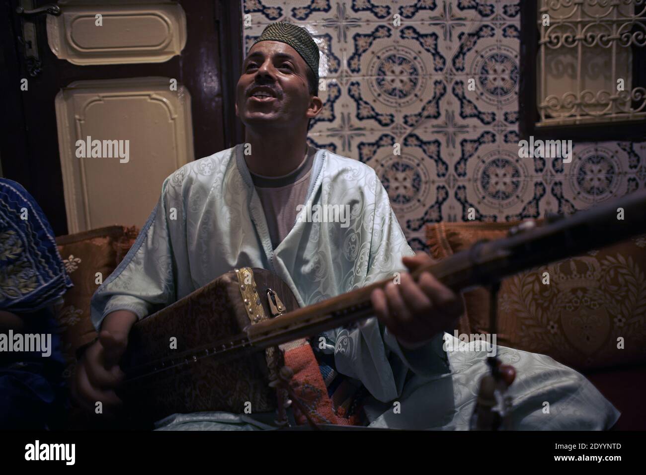 MAROKKO / Essaouira / DAS GNAWA- UND WELTMUSIKFESTIVAL von Essaouira / Musiker, der eine marokkanische Saitengitarre spielt. Stockfoto