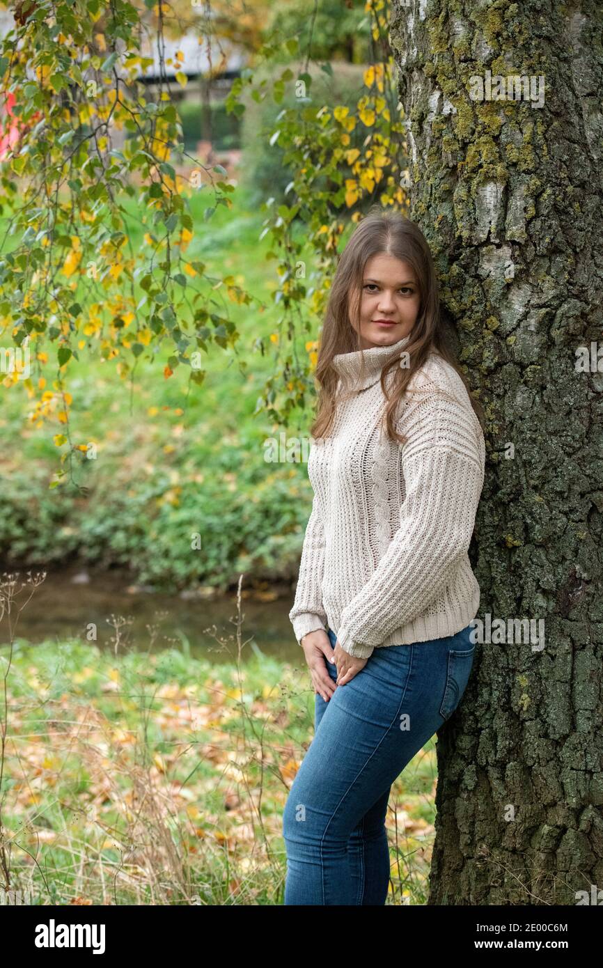 Junge Frau im Park vor gelben Blättern, Herbstsaison Stockfoto