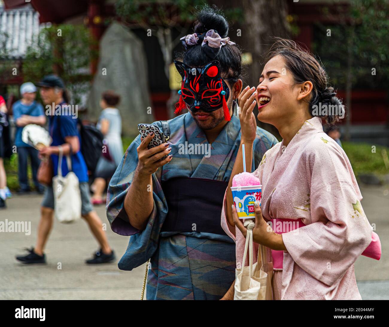 Bizarre Situation: kimono trägt ein maskiertes Paar. Straßenleben in Tokio, Japan Stockfoto