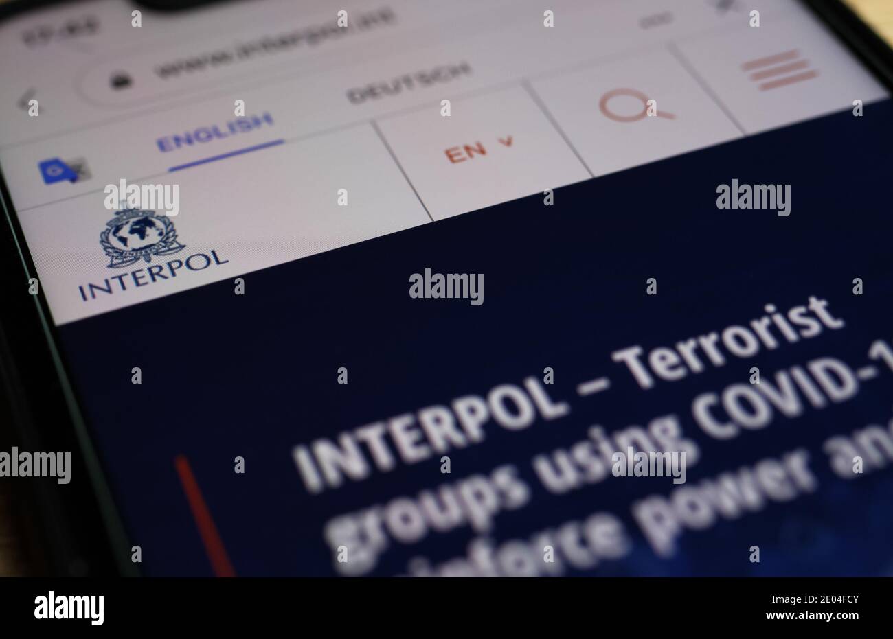 Viersen, Deutschland - Dezember 29. 2020: Nahaufnahme des Mobiltelefons mit der Website von interpol mit Warnung vor covid-19 Terroristen Stockfoto