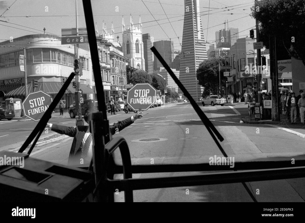 Beerdigung in Arbeit Mann hält ein Stop Funeral Zeichen, San Francisco Kalifornien USA 1999. 90er Jahre aus dem Inneren eines Greyhound-Busses. HOMER SYKES Stockfoto