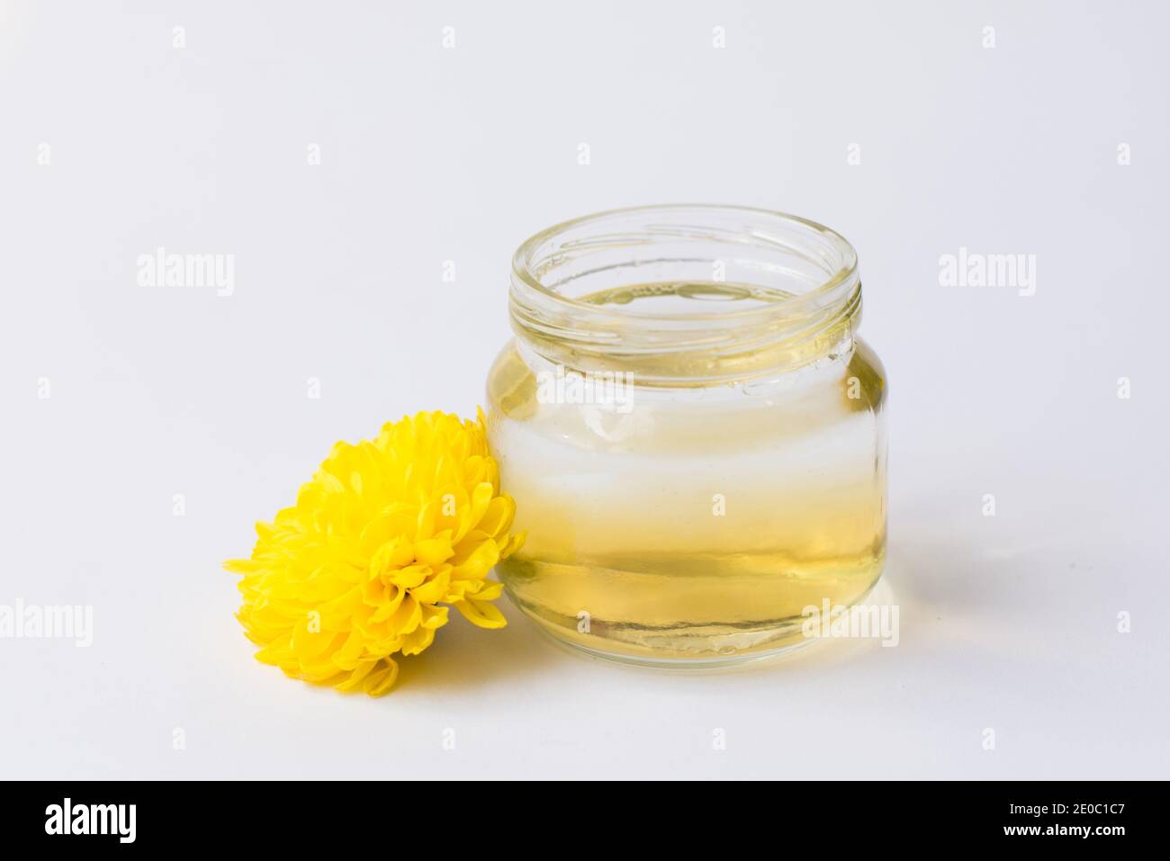 Flasche mit ätherischem Öl und frischen Blumen isoliert auf weiß Hintergrund Stockfoto