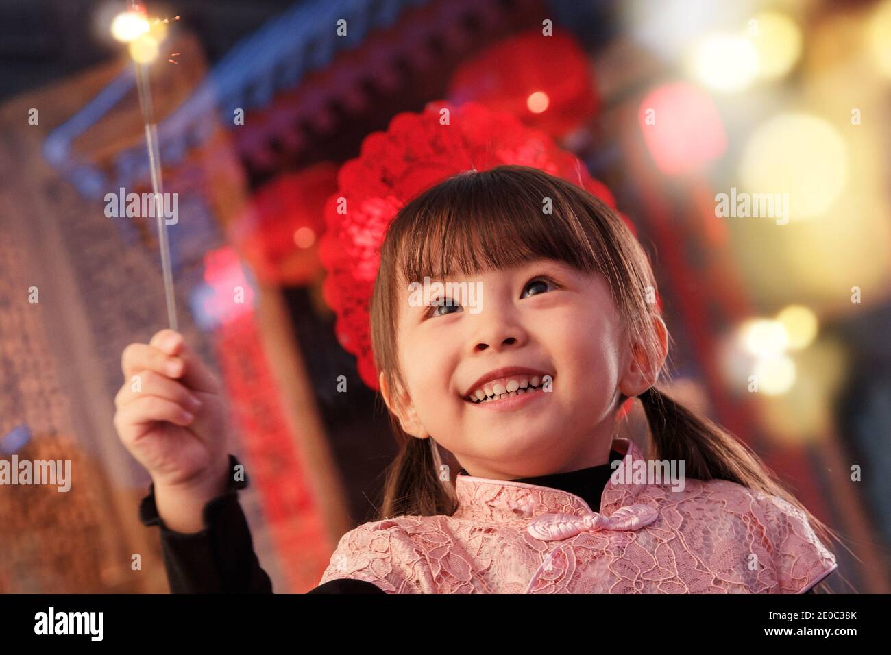 Das schöne kleine Mädchen mit Feuerwerk Stockfoto