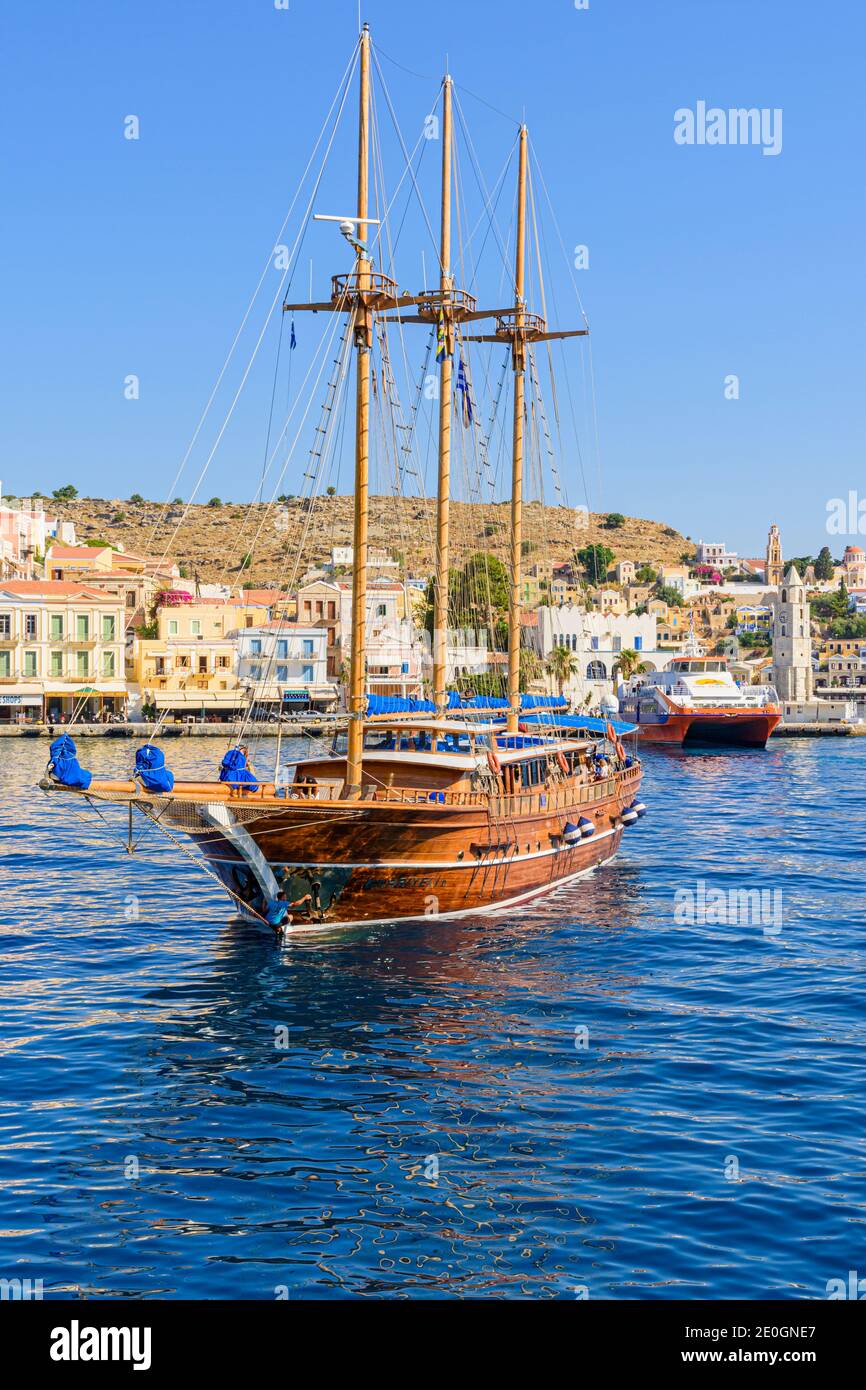 Ein türkischer Gulet fährt in den Hafen von Gialos, Symi Island, Dodekanes, Griechenland Stockfoto