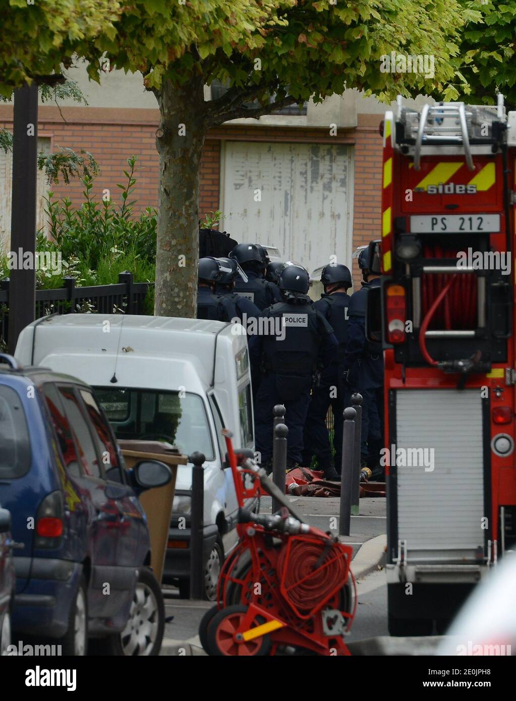 Am 10. Juli 2012, nach der Freilassung einer Gruppe von Kindern, die er in einer Schule in Vitry-sur-seine, am Stadtrand von Paris, Frankreich, gehalten hatte, wird eine Polizeiüberfalleinheit der Elite gesehen, wo ein bewaffneter Mann eine elterliche Geisel hält. Die Eltern seien gekommen, um ihr Kind an der Schule in Vitry-sur-seine abzusetzen, die während der Ferien als Freizeitzentrum genutzt wird, teilte die Polizei mit. Viele Schulen bieten Sommeraktivitäten während der Ferien an. Die Schule befindet sich im Zentrum der Stadt, selbst etwa 7.5 km (5 Meilen) vom Zentrum von Paris entfernt. Die Polizei wurde gegen 07:00 (05:00 GMT) in die Schule gerufen, wh Stockfoto