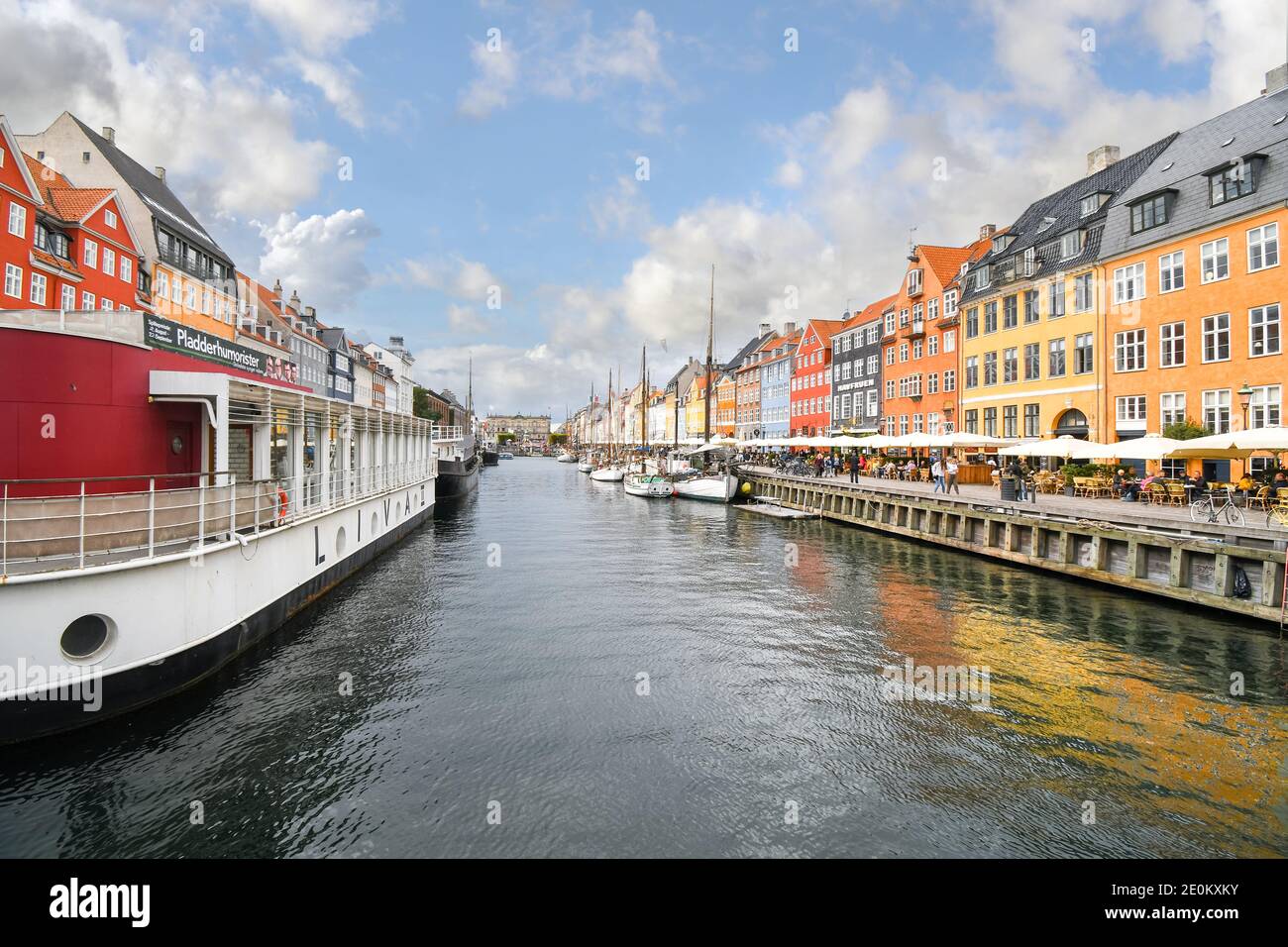 Touristen besichtigen, board Angelboote Speisen und Straßencafés an einem Herbsttag auf das 17. Jahrhundert waterfront canal Nyhavn in Kopenhagen, Dänemark. Stockfoto