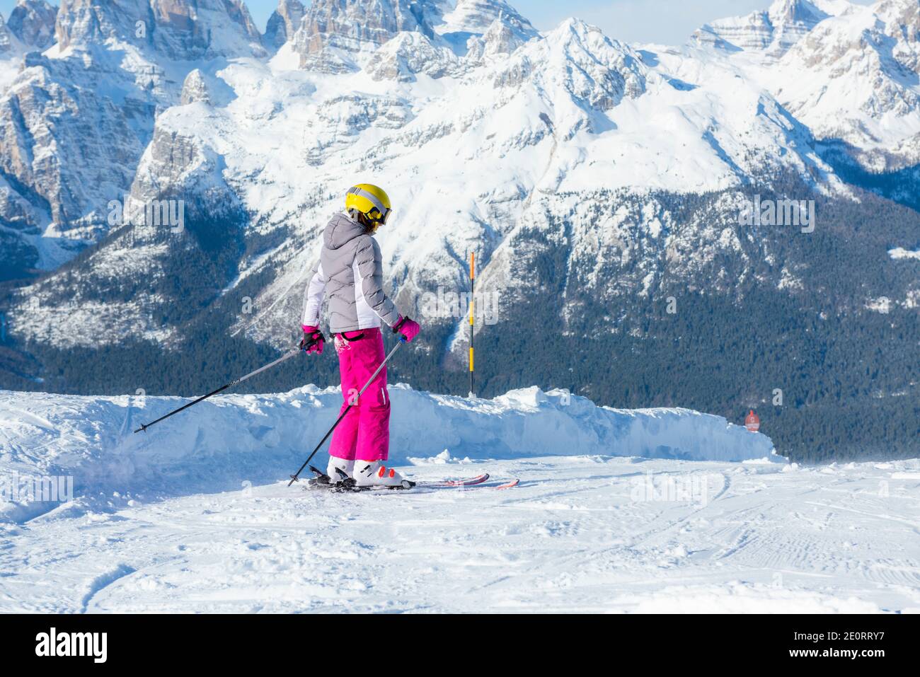 Glückliche Kinder mit Helm und Brille auf der Skipiste Stockfoto