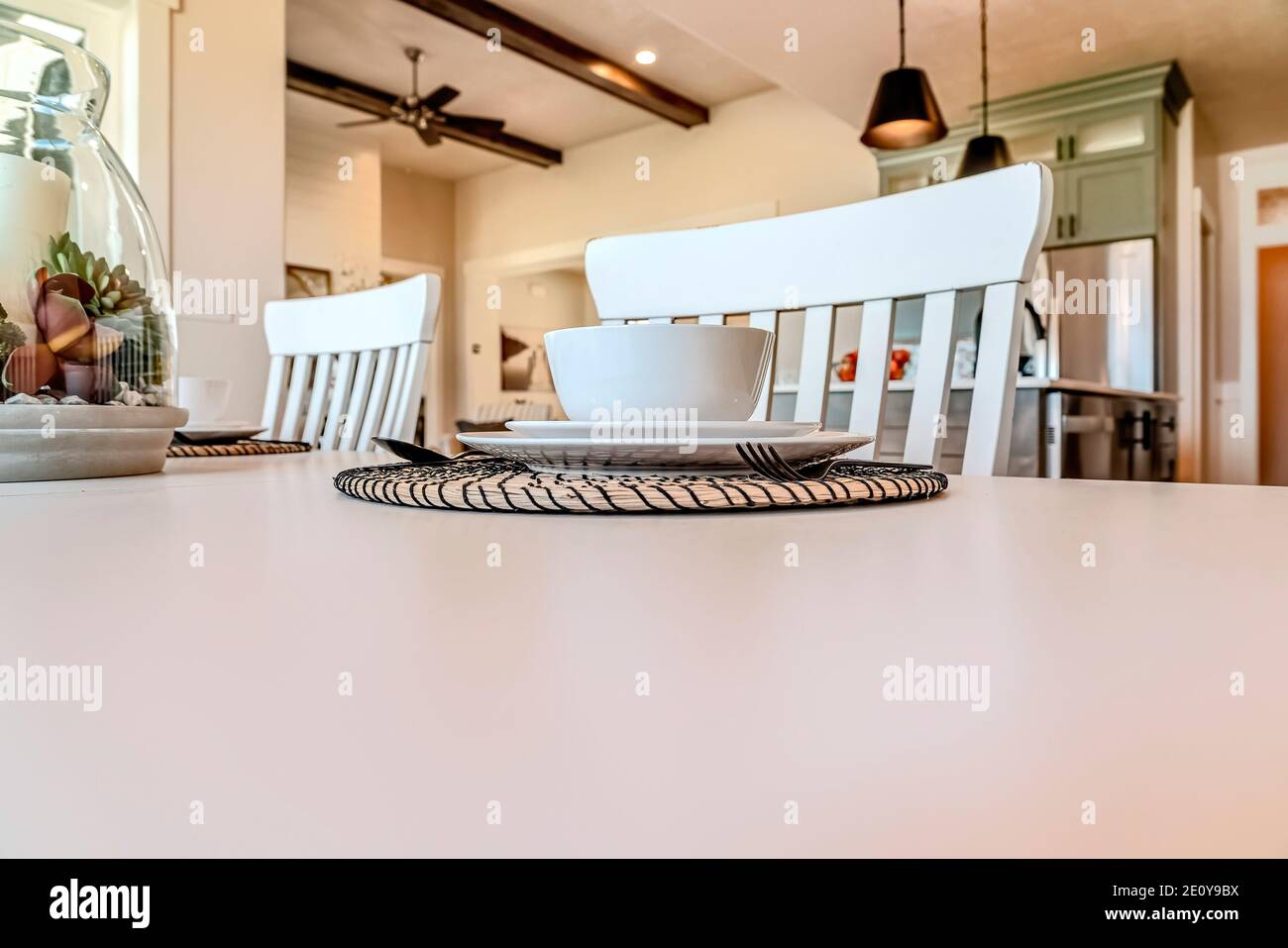 Nahaufnahme des weißen Esstisches mit Schüssel Untertasse Teller Und Utensilien auf dem Palcemat Stockfoto