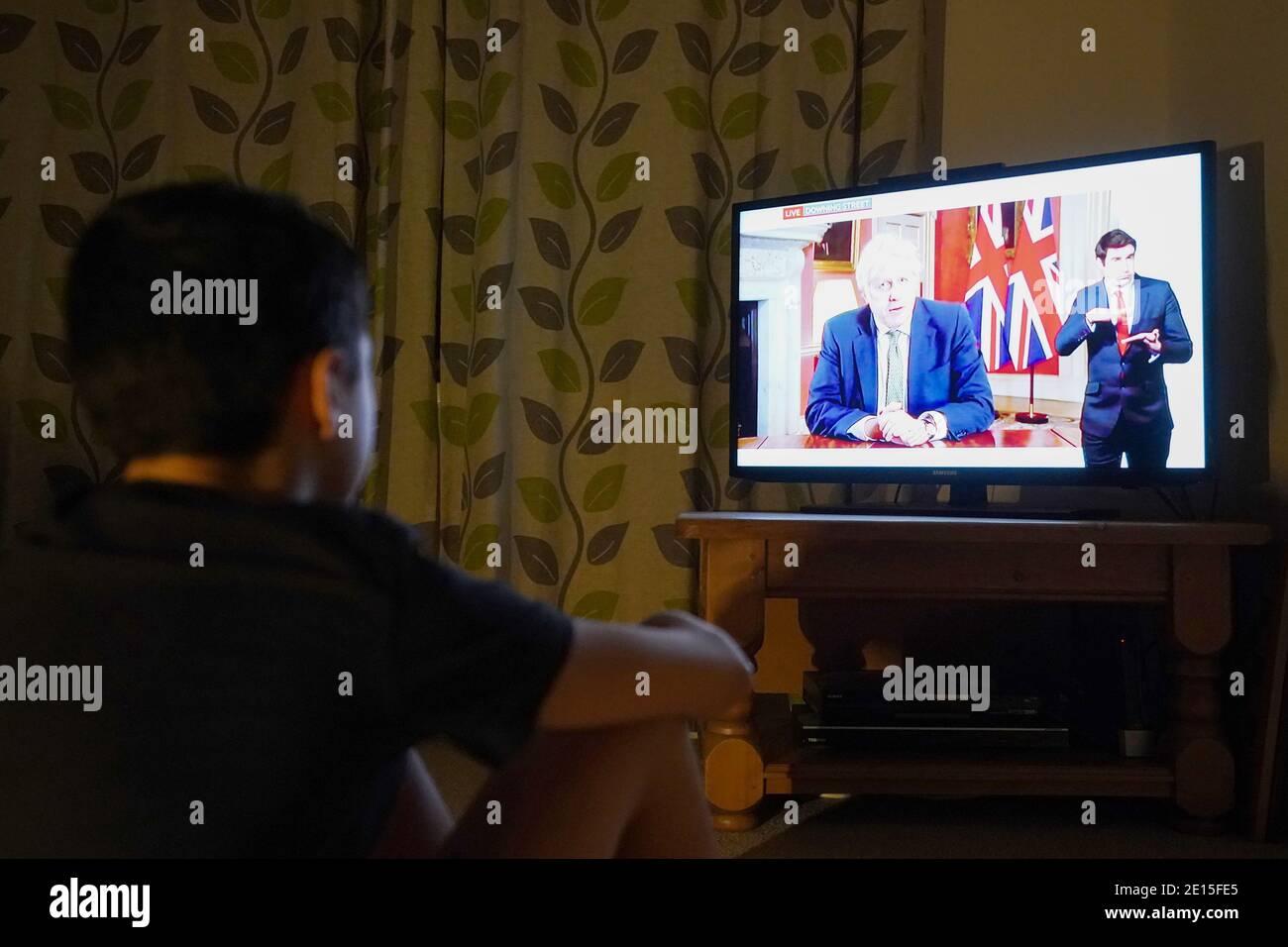 Ein Familienmitglied in Nottingham Frau beobachtet Premierminister Boris Johnson eine Fernsehansprache an die Nation von 10 Downing Street, London, die neue Notfallmaßnahmen zur Bekämpfung der Ausbreitung des Coronavirus in England. Stockfoto