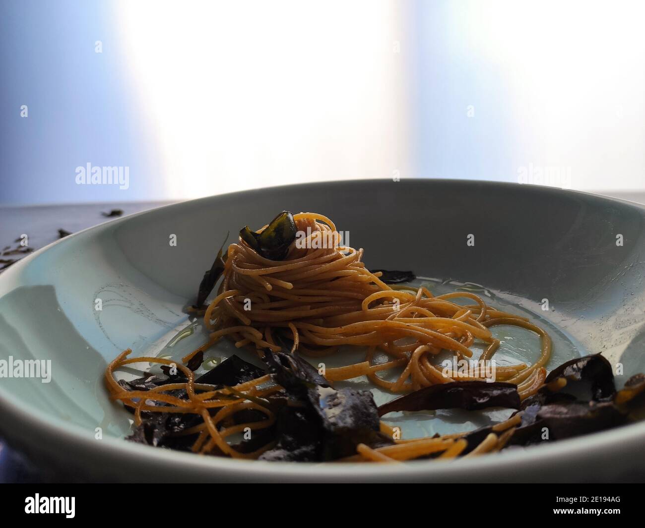 Kombu Seetang Spaghetti in einem blauen Teller Stockfoto