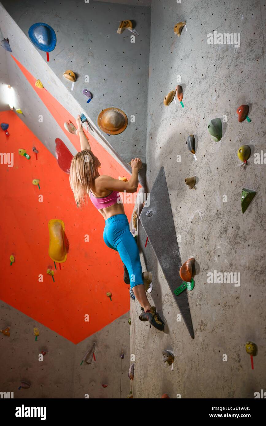 Kletterhalle. Junge Frau Kletterer Bouldering. Extreme Sport und Indoor Climbing Konzept Stockfoto