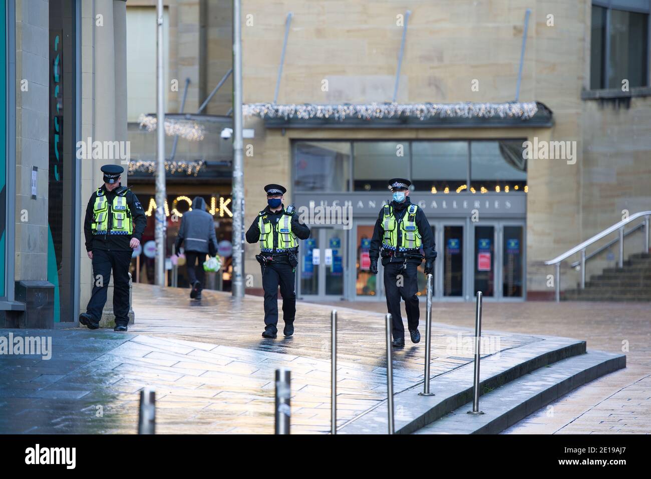 Glasgow, Schottland, Großbritannien. Januar 2021. Im Bild: Polizei Schottland Offiziere tragen hohe viz machen eine sehr sichtbare Präsenz, um die Sperre durchzusetzen. Glasgow City Centre sieht leer und verlassen aus am ersten Tag wird Schottland wieder gesperrt. Ab 00:01 Uhr heute Morgen wurde Schottland erneut gesperrt, wie es die Ansprache des schottischen Ersten Ministers gestern um 14:00 Uhr erklärte. Nur wesentliche Reisen sind erlaubt, wie zum Beispiel zur Arbeit gehen und wichtige Lebensmittel einkaufen und Sport treiben, abgesehen davon, dass jeder in seinem Haus bleiben muss. Quelle: Colin Fisher/Alamy Live News Stockfoto
