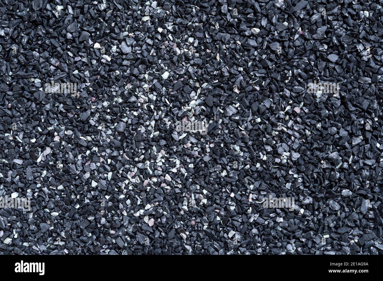 Schwarze Sandstruktur. Vollformat-Makrofotografie von dunkler rauer Sandoberfläche. Abstraktes Muster Hintergrund. Design-Element aus der Nähe. Draufsicht. Stockfoto