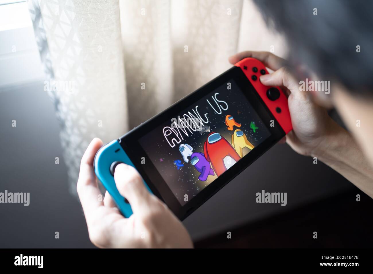Bangkok, Thailand - 16. Dezember 2020 : EIN Mann spielt unter uns, das beste Mobile Spiel bei den Game Awards 2020, auf Nintendo Switch. Stockfoto