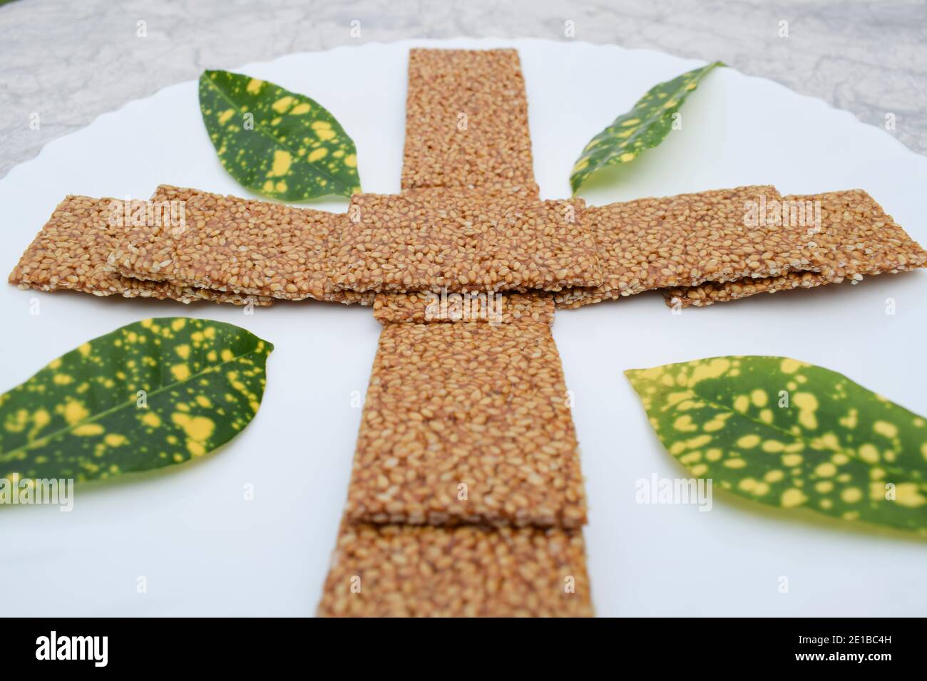 Til sakri oder Tilgul eine indische traditionelle beliebte Süßigkeit aus Sesamsamen und Jaggery. Berühmte Sankranti Festival Dessert arrangiert dekoriert mit Witz Stockfoto