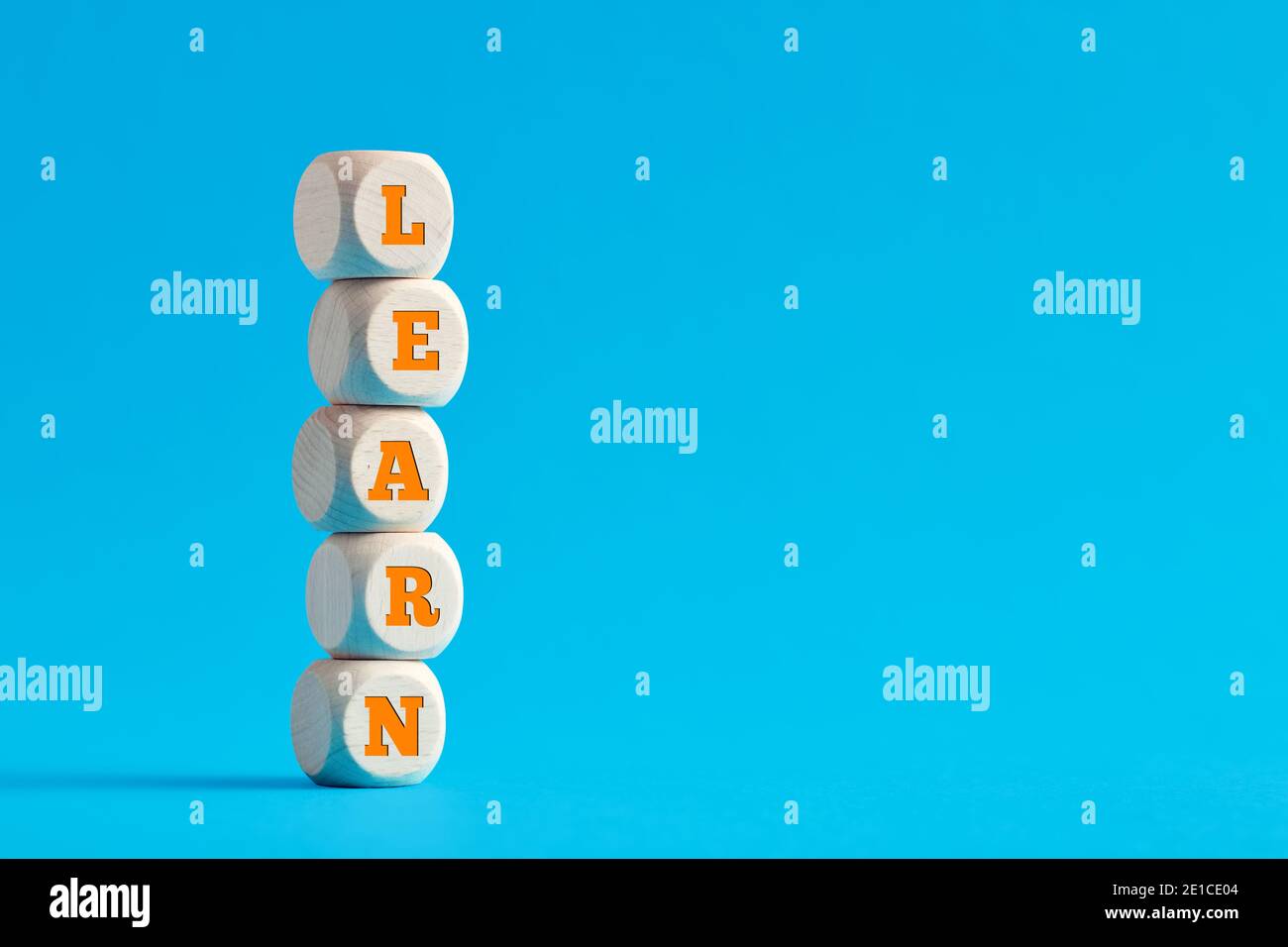 Das Wort lernen auf gestufte Holzwürfel auf blauem Hintergrund. Stockfoto