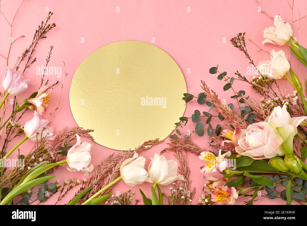 Hoher Winkel von verschiedenen blühenden Blumen und Pflanzen angeordnet auf Rosa Hintergrund mit golden glänzend runden Papier Stockfoto