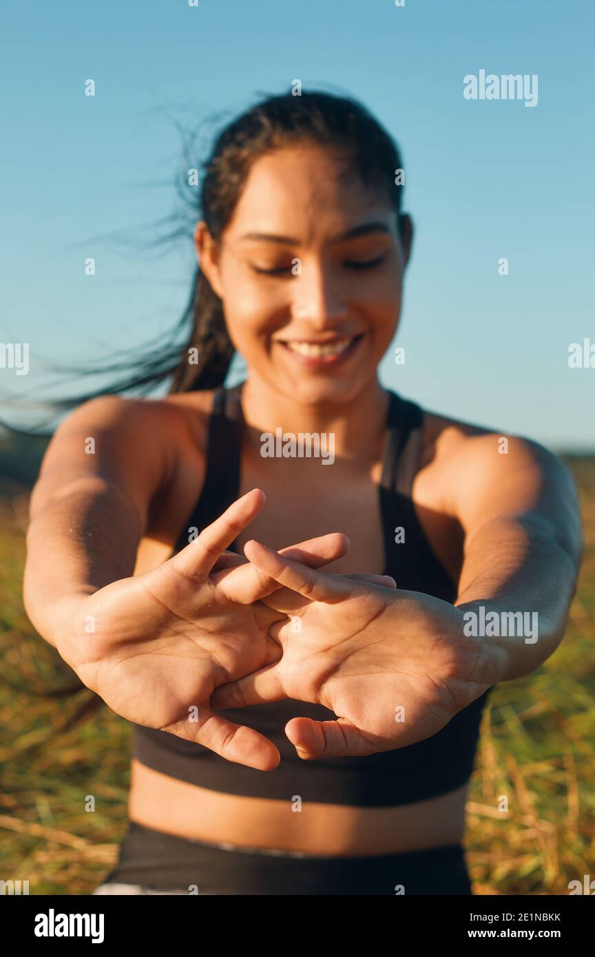 Ein flacher Fokus auf die Hände, glückliche Frau streckt ihren Körper im Freien Stockfoto