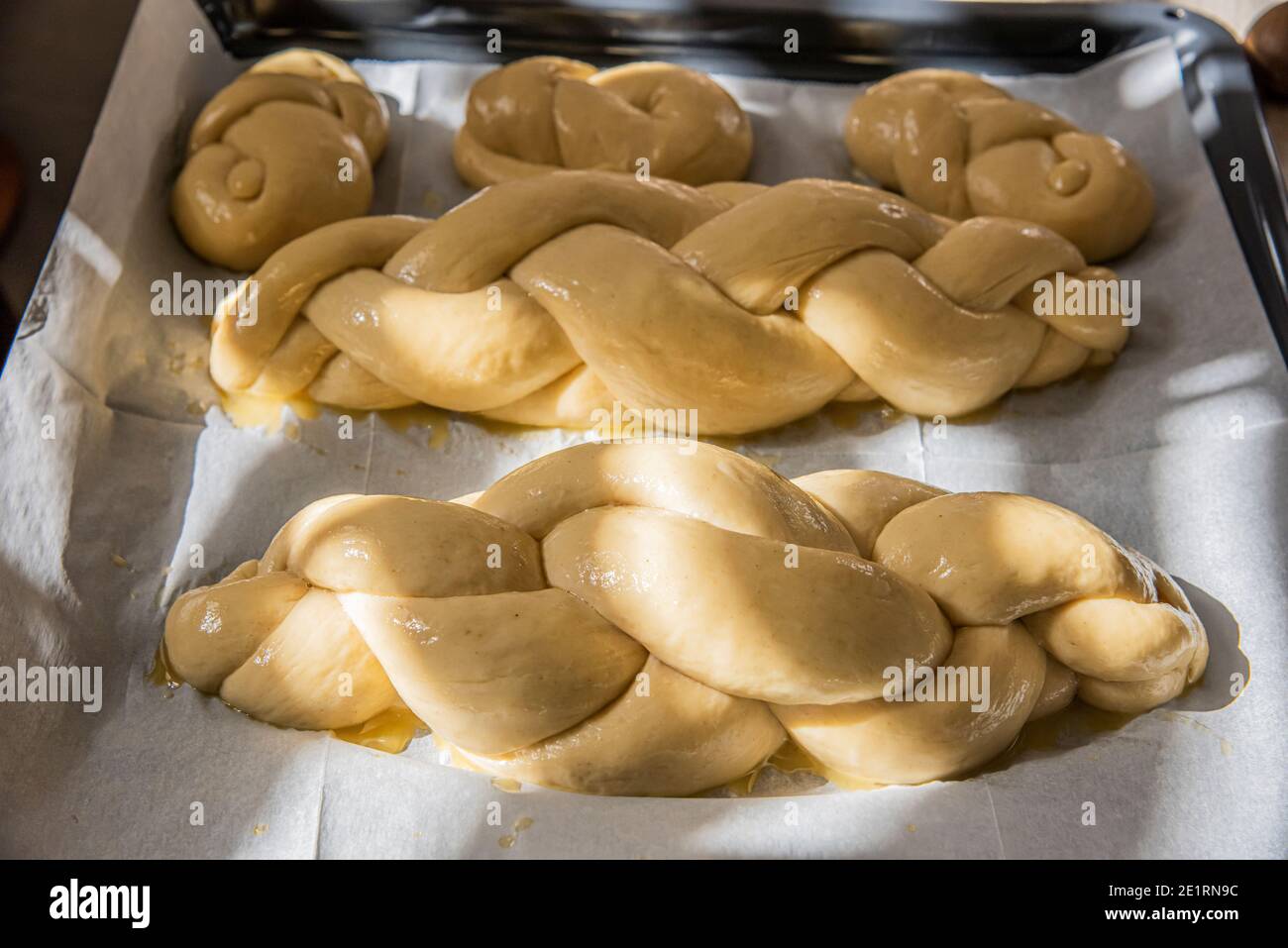 Hausgemachtes Challah-Brot backen. Vor dem Backen in einer Pfanne mit Sesamsamen umflechten. Der Teig puffte vor dem Backen. Hochwertige Fotos Stockfoto