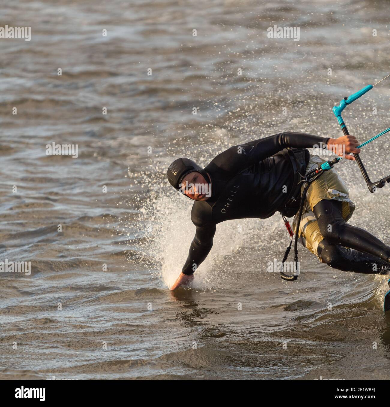 Kite Surfer gleitet auf einer sehr hohen Geschwindigkeit und berührt das Wasser. Selektiver Fokus, Kopierbereich für Text, Sportfoto. Stockfoto