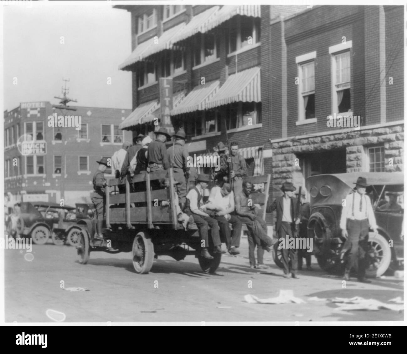 Vintage-Foto der Nationalgarde und verwundeten Bürger während der Unruhen in Tulsa 1921. Lastwagen auf der Straße in der Nähe des Litan Hotels. Stockfoto