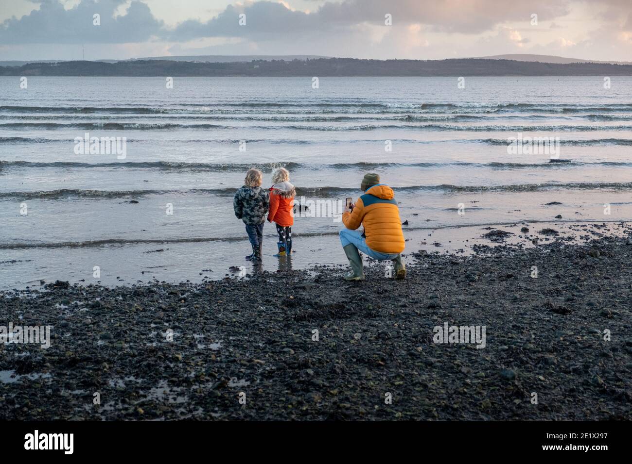 Vater fotografieren seine kleinen Kinder während Winter Küstenwanderung. Lepe, Hampshire. England Stockfoto