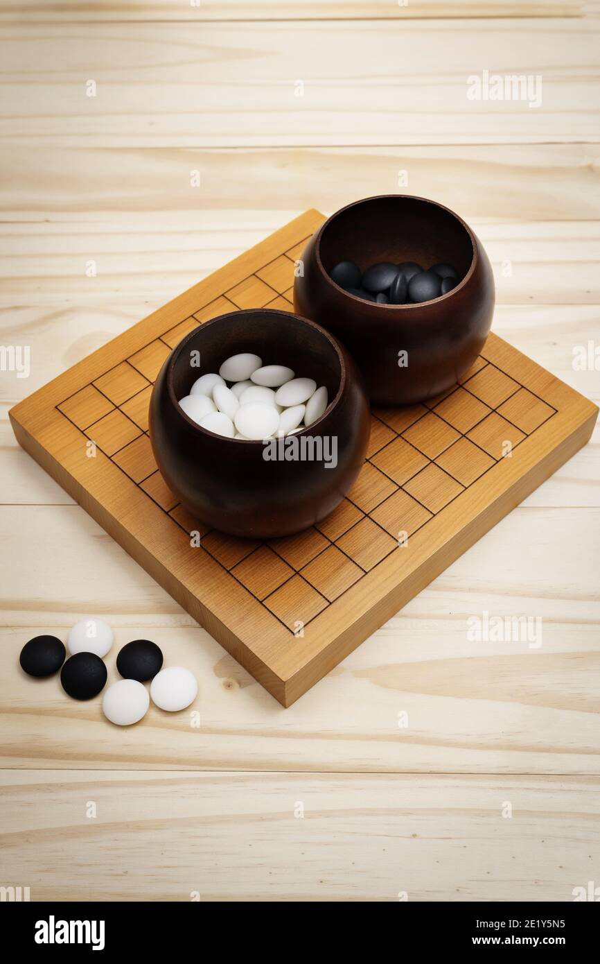 Go Game, Goban, Baduk oder Weiqi (chinesisches Brettspiel) Hintergrund Stockfoto