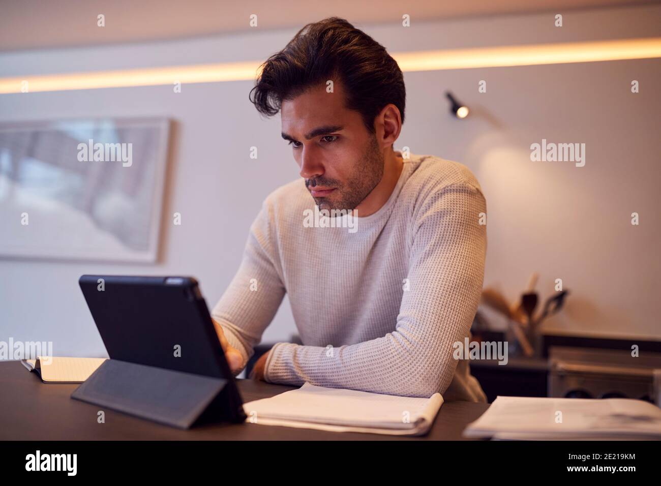 Mann In Der Küche Arbeiten Oder Studieren Von Zu Hause Aus Mit Digital Tablet Stockfoto